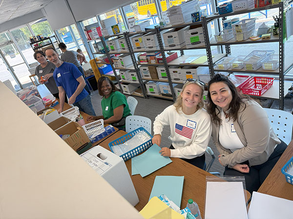 People distributing school supplies