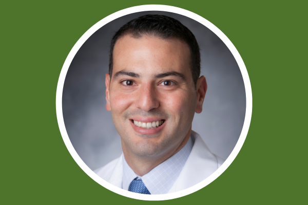 Headshot of Dr. Abi on Duke green background