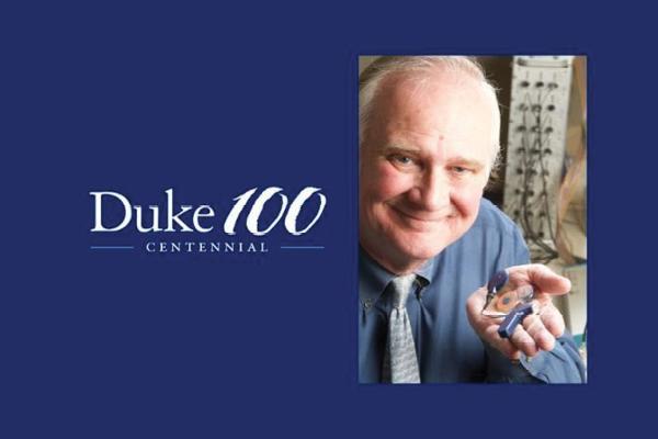 Image of Blake Wilson holding a cochlear implant