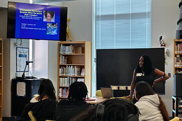 Dr. Cannon at the front of the room presenting to students