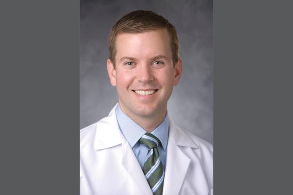 Dr. Woodard profile on gray background