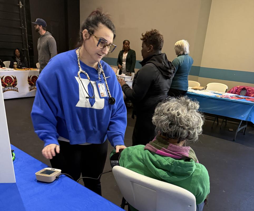 Duke Employee checking a person's blood pressure