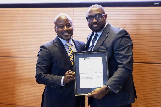 Dr. Francis and Dr. Osazuwa-Peters with the latter holding an award
