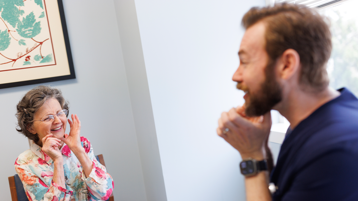 Speech therapist Ryan Downey, right, works with patient Linda Stansel during her final appointment at Duke Otolaryngology Clinic in Raleigh