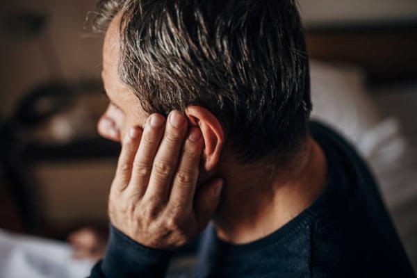 Elder man experiencing hearing loss.