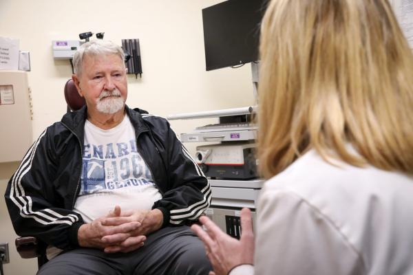 A patient discusses his care plan at the POSH clinic.