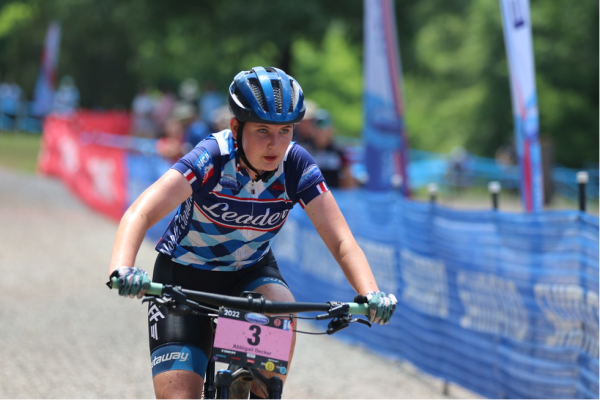 Competitive mountain biker Abbie Decker closes in on a competitor in the last lap of a race in May 2022. | Photo credit: Deborah Hage