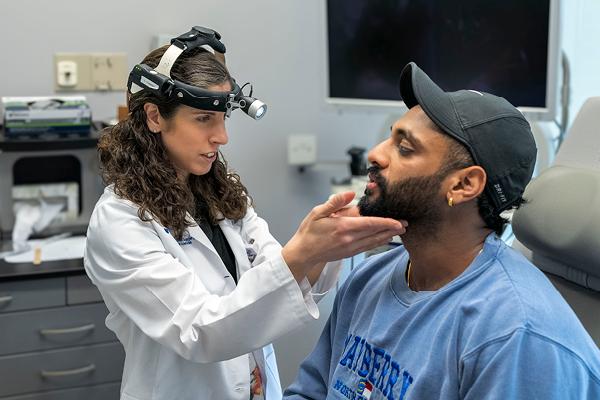 Emily Commesso examining a patient