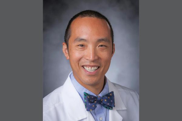 Headshot of Dr. Cheng on gray background 