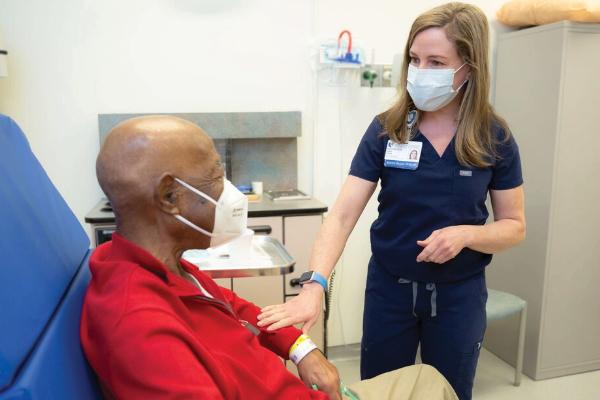Gina Vess with Patient in clinic