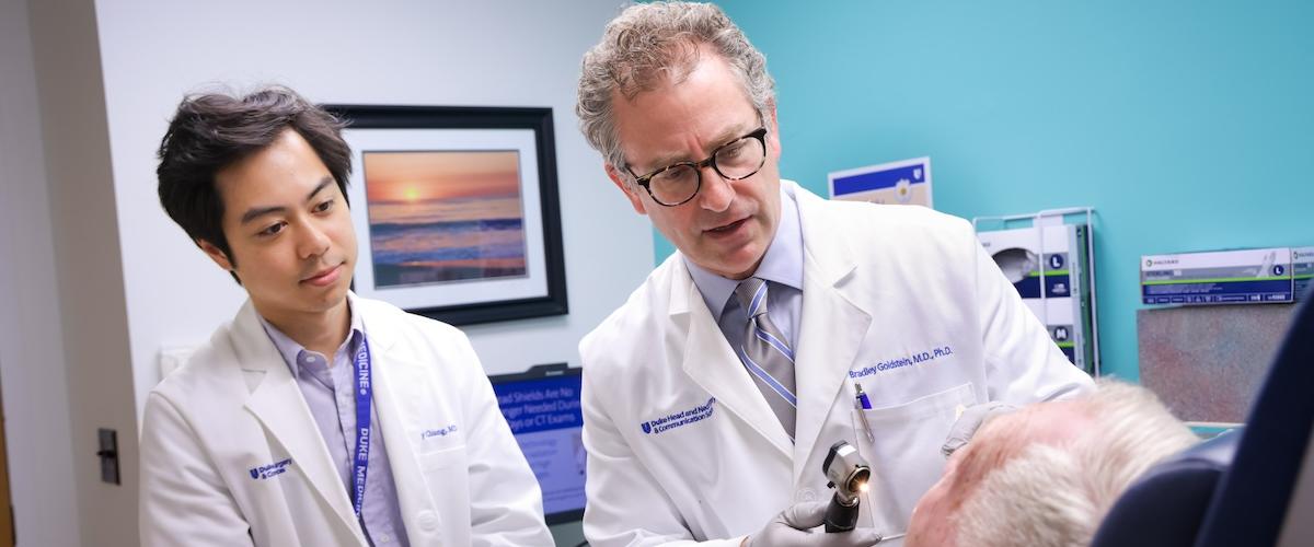 Two doctors examine a patient