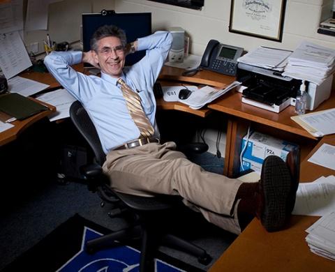 Dr. Lefkowitz sits with his legs up on his desk