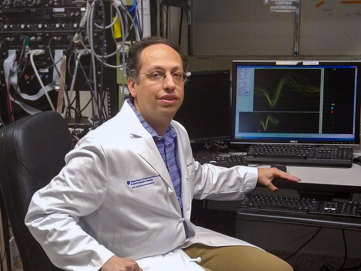 Dr. Steven Eliades, Associate Professor of HNS&CS, sits at a computer while conducting research analysis.