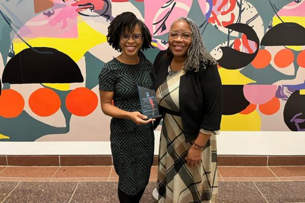 Dr. Minga and Dr. RaMonda Horton standing next to each other with award in hand