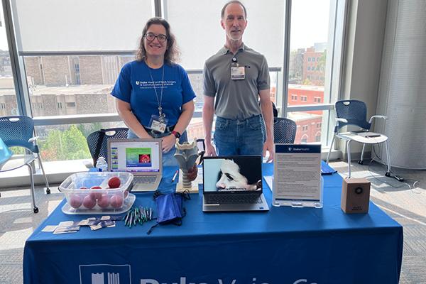 Dr. Raynor and Dan Sherwood at the Duke Health table