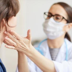 iStock image: Physician checking glands under patients chin