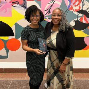 Dr. Minga and  Dr. RaMonda Horton standing next to each other with award in hand