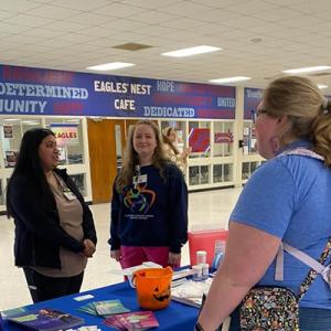 Meredith talking to a student 
