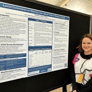 Jessie West in front of poster at American Auditory Society Conference 