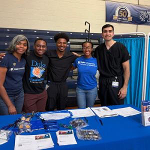 HNS&CS team behind a table at a Head and Neck Screening Event 