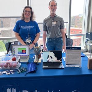 Dr. Raynor and Dan Sherwood at the Duke Health table 