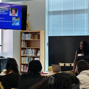 Dr. Cannon at the front of the room presenting to students