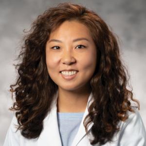 Profile of Sarah Kim on blue background