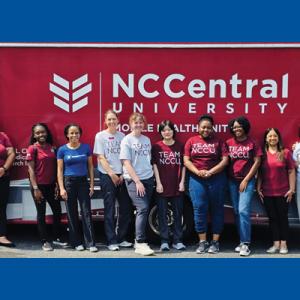 Group photo of all participants in front of NCCU bus