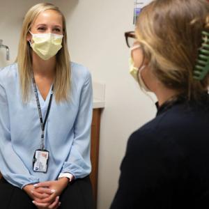 Photo of Duke sleep specialist Marjorie Soltis, MD, talking to patient