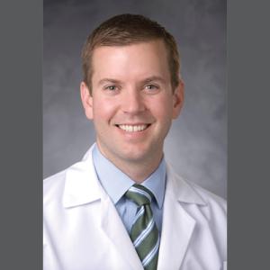 Dr. Woodard profile on gray background